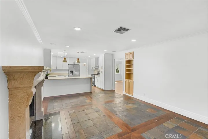 Family room looking back towards kitchen.  Cabinets built into the wall and a glass pocket door separates the living room and dining room area for excellent noise privacy.