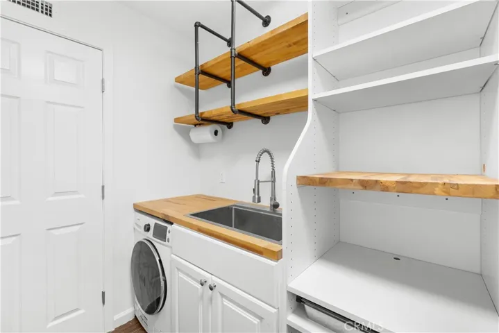 Primary walk-in closet with kitchenette.