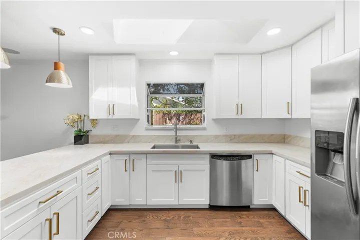 Kitchen has tremendous cabinet storage and counter space, and a window box that overlooks the garden and fountain.