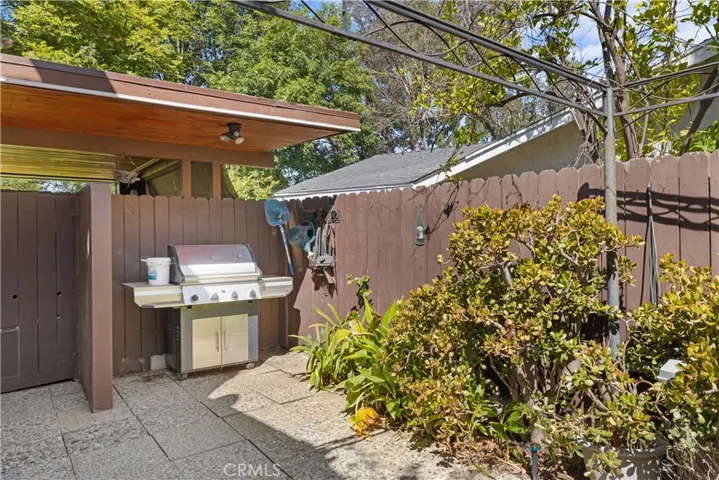 Side yard covered BBQ area with flood light.