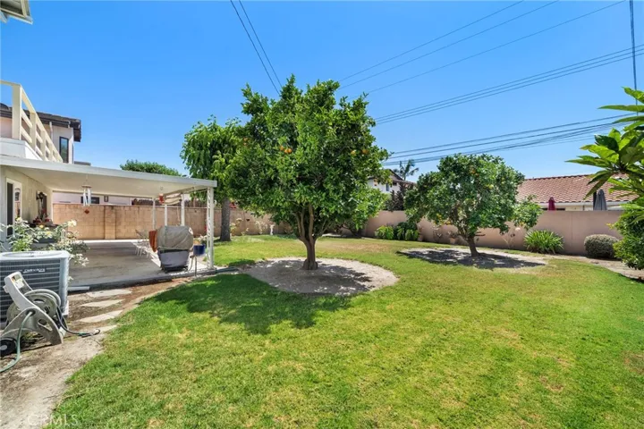 Sprawling lawn, manicured gardens, lush foliage, and ornamental trees