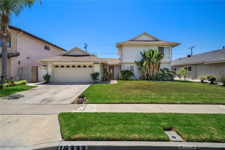 Lovely curb appeal with lush lawn and tropical landscaping