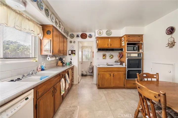 Tile countertops and natural wood cabinetry