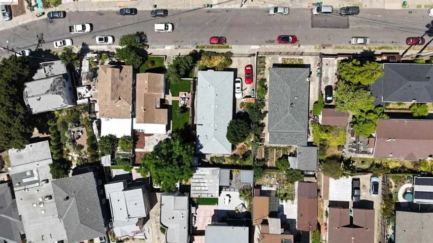 Residential property featuring a rectangular footprint, a visible driveway, and surrounding green landscaping