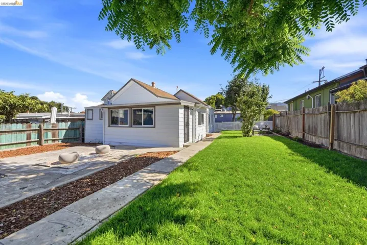 Expansive grassy yard with perimeter fencing