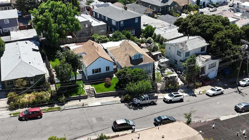 Two distinct properties with separate addresses, each featuring a pitched roof and light-colored siding