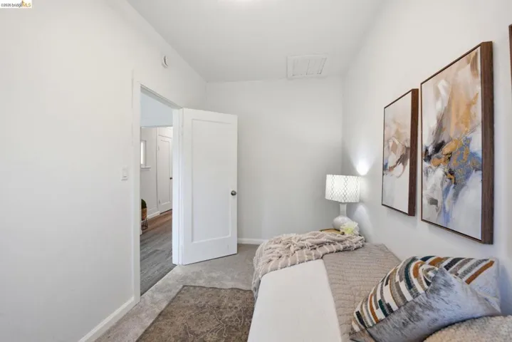 Carpeted bedroom featuring white painted walls and trim