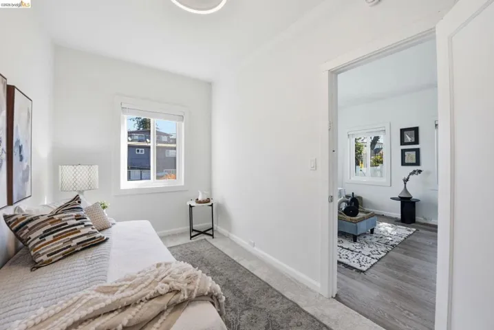 Neutral-toned carpeting extends throughout this interior space, featuring a single window with white trim