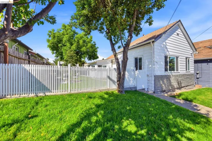 White picket fence enclosing a grassy yard