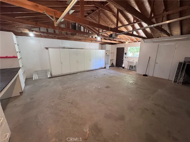 two car garage with utility sink and toilet and shower
