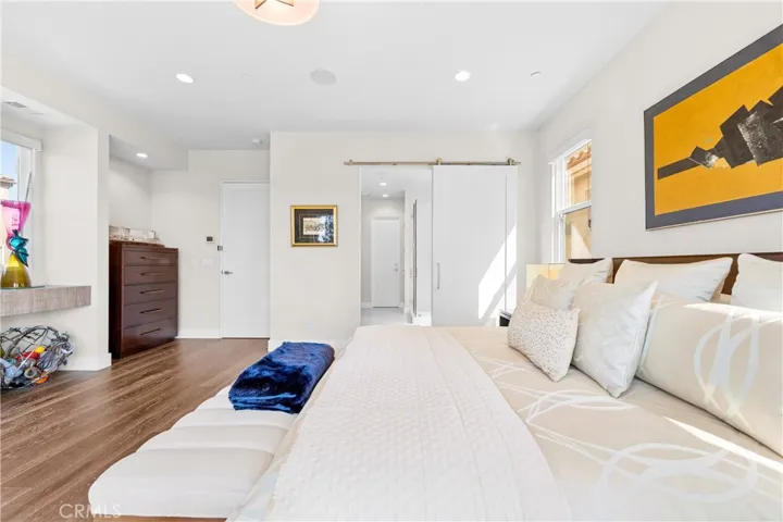 Luxurious primary suite offers a fireplace, private balcony, designer lighting, and a spa inspired en-suite bath, with a perfectly designed walk-in closet. Motorized shades provide effortless privacy and light control.