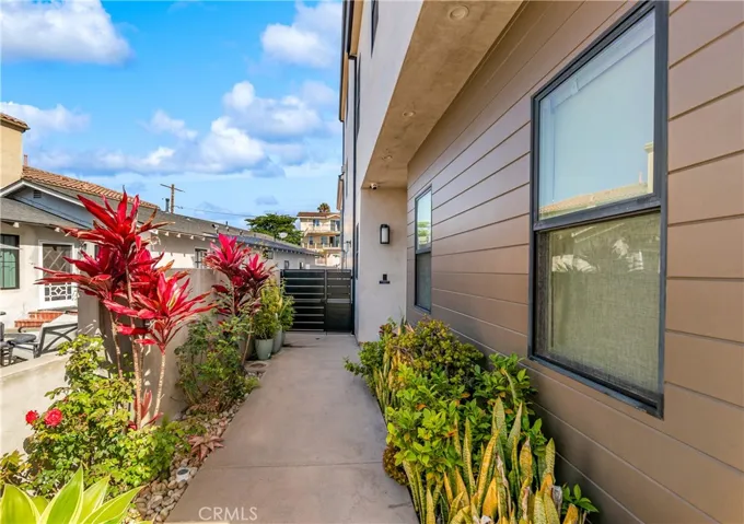 Lush landscaping and a welcoming approach lead to a stunning glass entry.