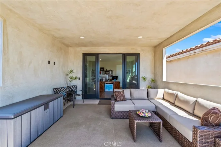 Designed for year-round enjoyment, this versatile terrace includes a covered lounge area with TV wiring, recessed lighting and an open-air sun deck