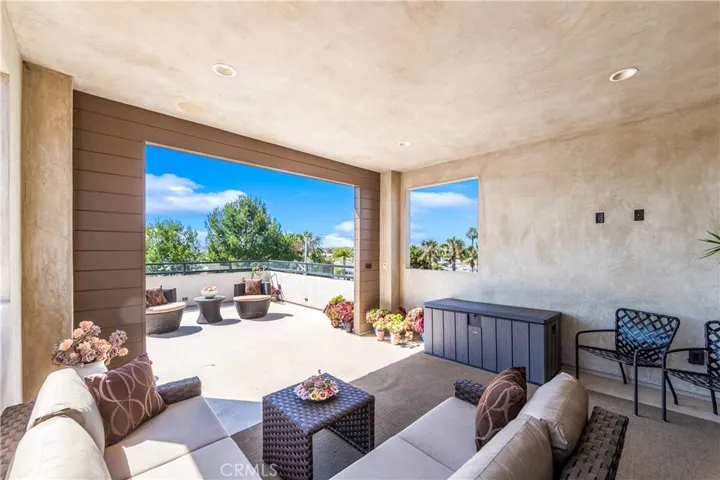 Designed for year-round enjoyment, this versatile terrace includes a covered lounge area with TV wiring, recessed lighting and an open-air sun deck