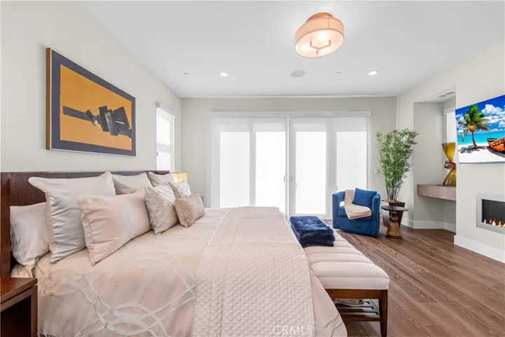 Luxurious primary suite offers a fireplace, private balcony, designer lighting, and a spa inspired en-suite bath, with a perfectly designed walk-in closet. Motorized shades provide effortless privacy and light control.
