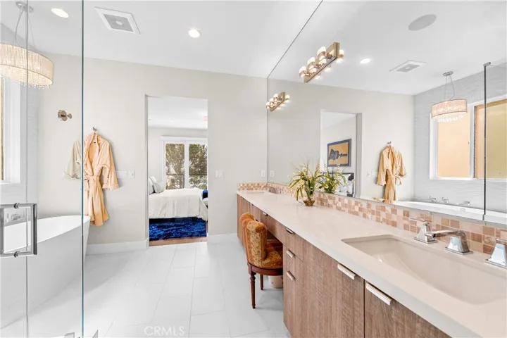 Spa-inspired primary bath showcases a Victoria + Albert soaking tub, seamless glass shower, designer lighting and impeccable finishes throughout.