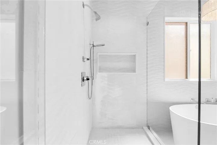 Spa-inspired primary bath showcases a Victoria + Albert soaking tub, seamless glass shower, designer lighting and impeccable finishes throughout.