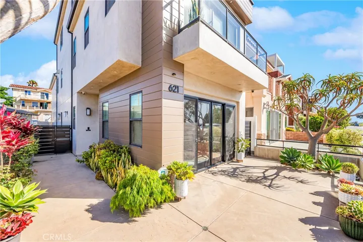 Coastal contemporary with expansive glass and exceptional curb appeal. A short walk to the beach!