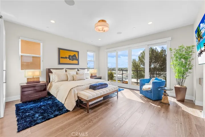 Luxurious primary suite offers a fireplace, private balcony, designer lighting, and a spa inspired en-suite bath, with a perfectly designed walk-in closet. Motorized shades provide effortless privacy and light control.