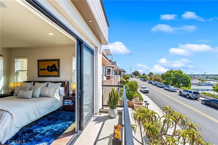 Luxurious primary suite offers a fireplace, private balcony, designer lighting, and a spa inspired en-suite bath, with a perfectly designed walk-in closet. Motorized shades provide effortless privacy and light control.