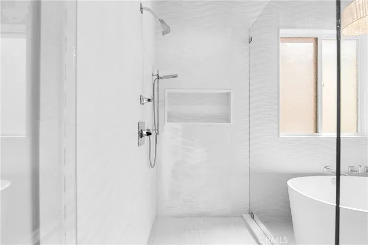 Spa-inspired primary bath showcases a Victoria + Albert soaking tub, seamless glass shower, designer lighting and impeccable finishes throughout.