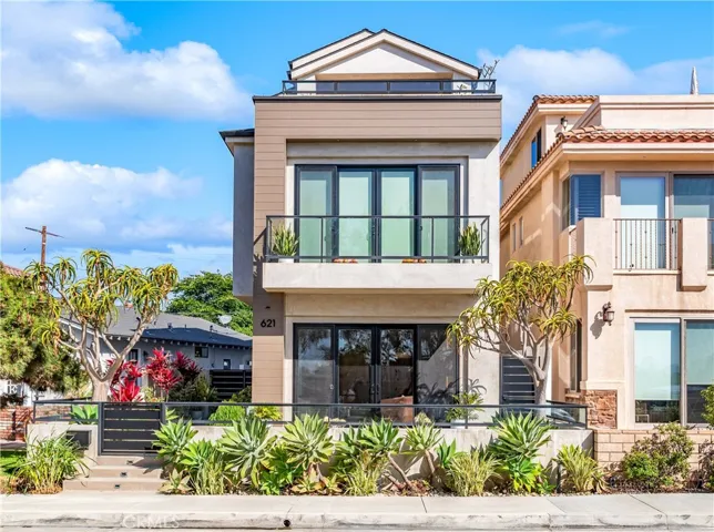 Custom coastal contemporary architecture by Goodman Development, ideally positioned on an elevated Downtown Huntington Beach lot.