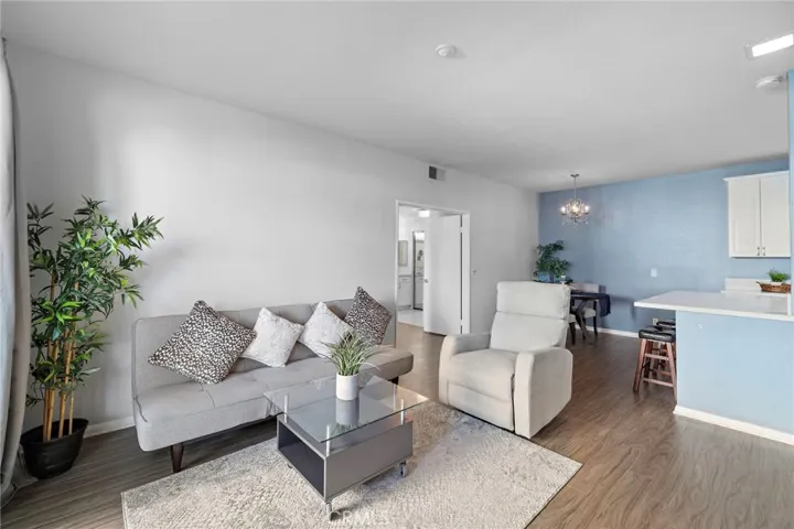 Living Room: Spacious open-concept living room with durable flooring and seamless flow into the dining area and kitchen.