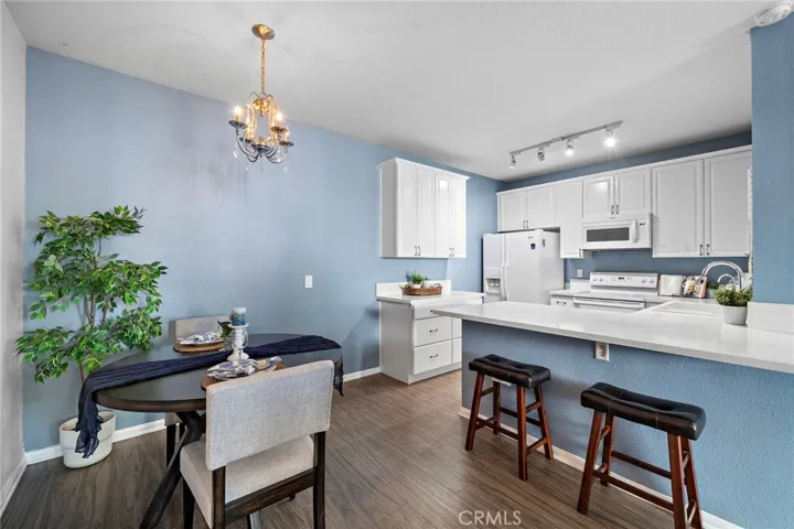 Dining Area & Kitchen: Open dining area and bright kitchen featuring a breakfast bar, ample cabinetry, and a functional open-concept design.