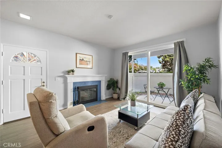 Living Room: Bright living room with a cozy fireplace, private patio access, and abundant natural light.