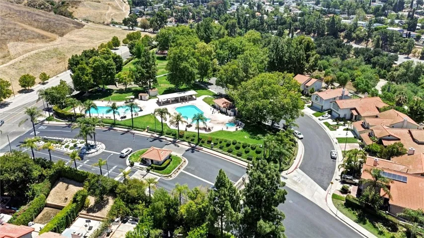 Drone shot of community entrance & pools.