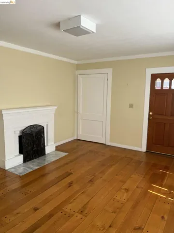 Warm wood-finish flooring complements the light wall color