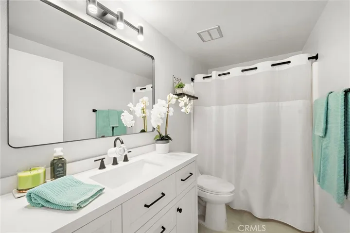 Remodeled hall bathroom w/ new vanity, mirror and lighting