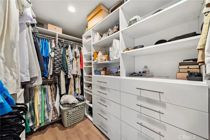 Primary walk-in closet with custom built-ins