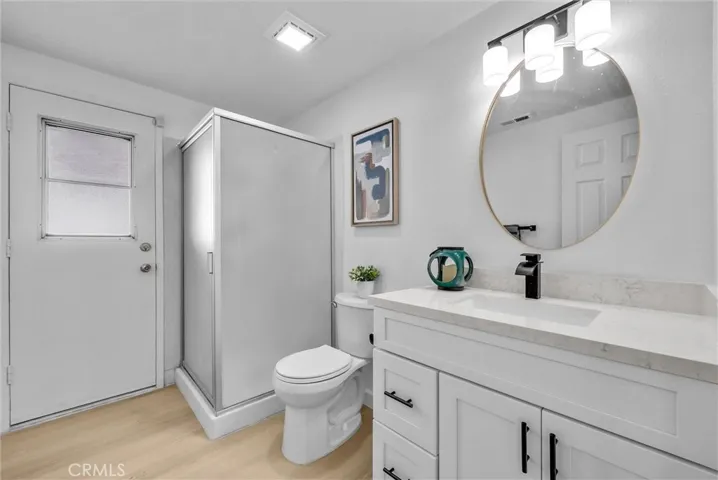 Downstairs full bathroom with a door access to the yard