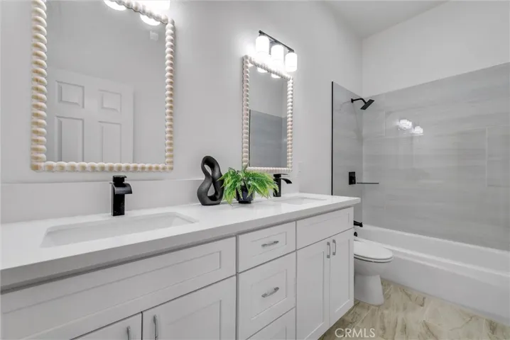Remodeled shared bathroom with dual sinks