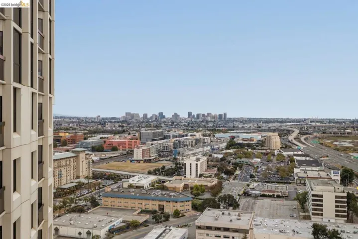 Expansive urban landscape featuring multiple city skylines, a multi-lane highway, and diverse architectural buildings