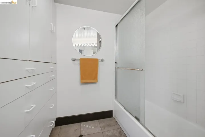White integrated cabinetry with drawers and upper storage