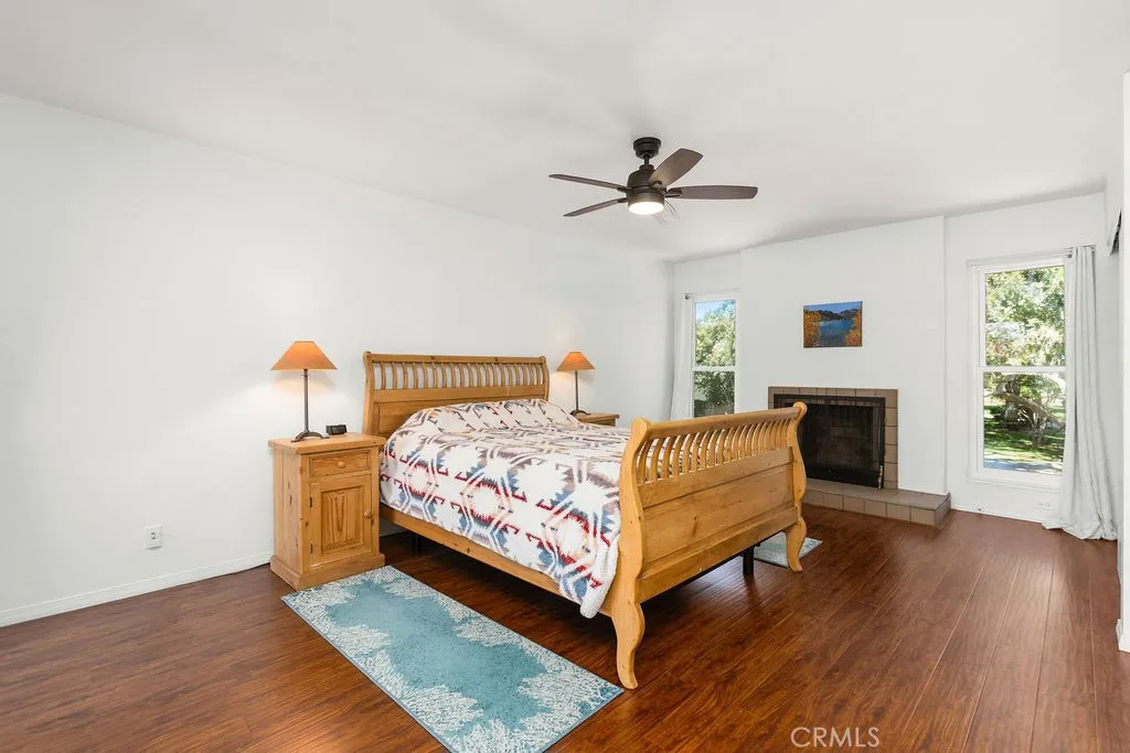 Primary bedroom with cozy fireplace and wonderful views of the park.