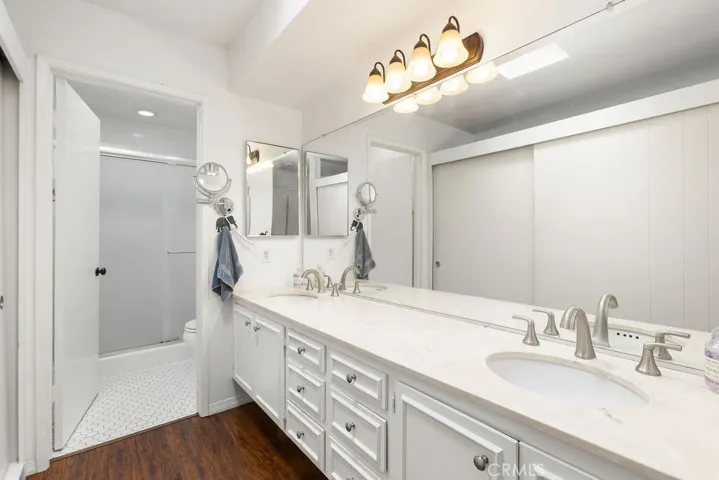 Primary bath offers dual vanity + remodeled shower.