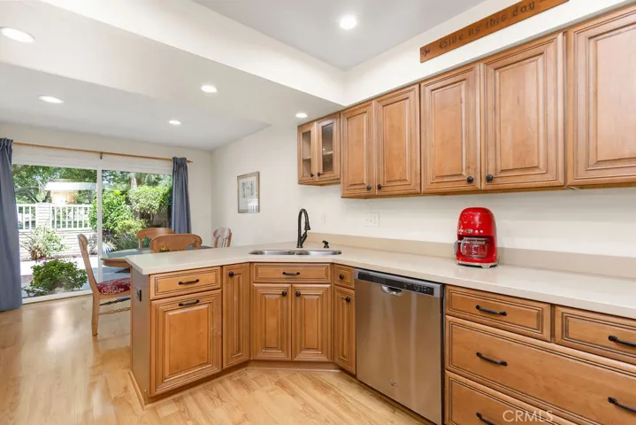 Remodeled kitchen with ample cabinetry with (pull-outs) to maximize storage space --- opens to dining area with direct access to backyard & park views.
