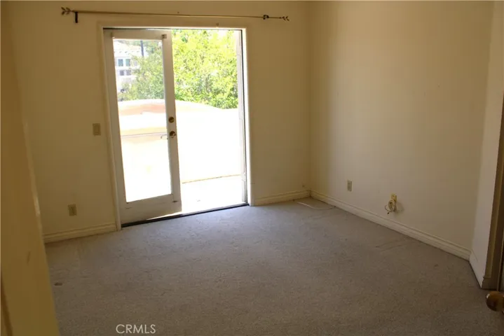 Secondary upstairs bedroom with a balcony to the rear of the property