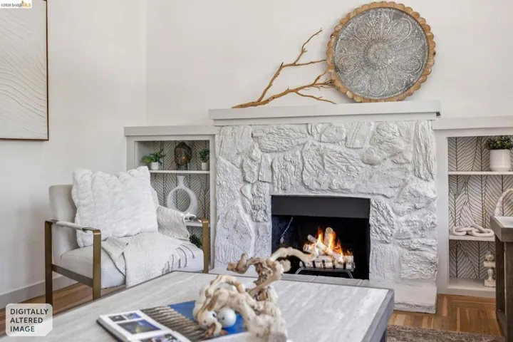 Stone-clad fireplace with a recessed firebox, flanked by built-in shelving with decorative backing