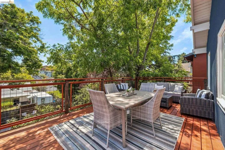 Expansive outdoor deck featuring wood-finish flooring, a wire-panel railing, and direct access to the exterior of the property