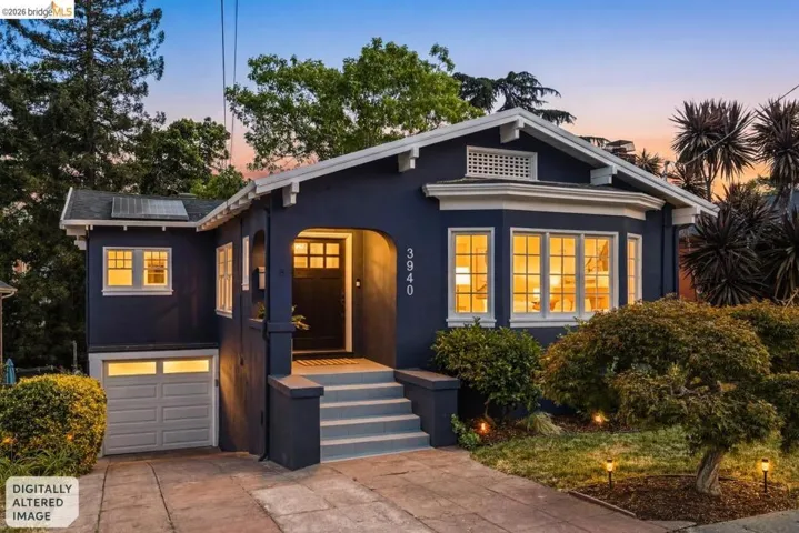 Deep blue exterior with white trim, featuring a recessed entry, bay window with multiple panes, and an integrated garage with a light-colored door
