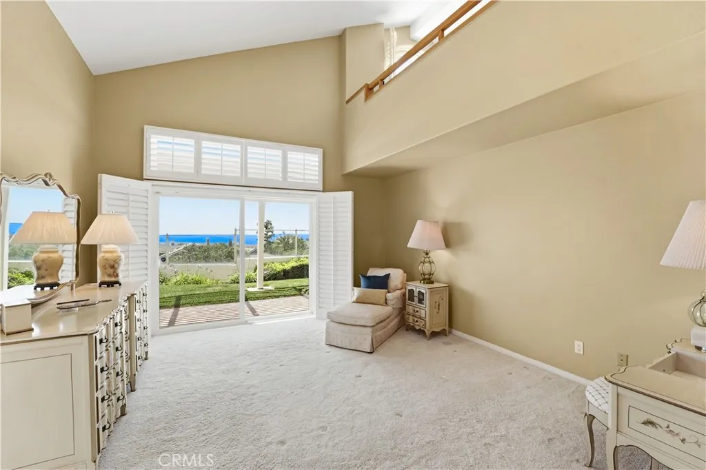 Primary bedroom with a panoramic ocean view sliding glass door.  You can move in a very large bed.