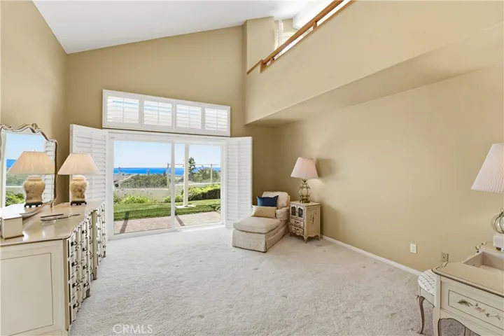 Primary bedroom with a panoramic ocean view sliding glass door.  You can move in a very large bed.