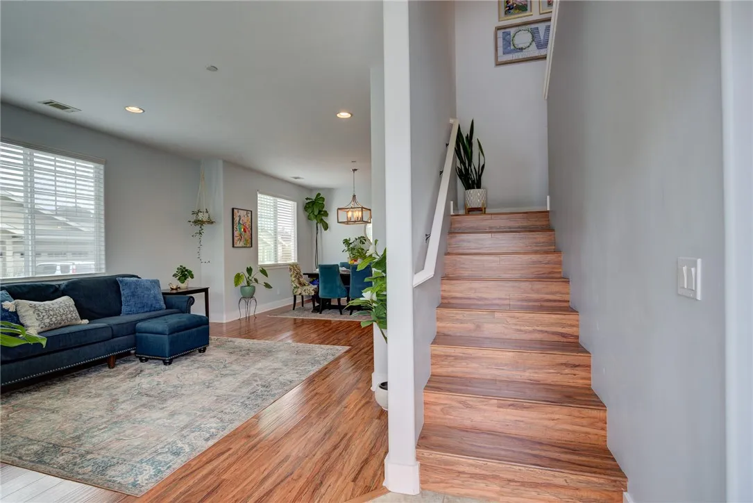 Entryway with living room to the left, hall bath, laundry, and primary bedroom to the right Entryway with living room to the left, hall bath, laundry, and primary bedroom to the right