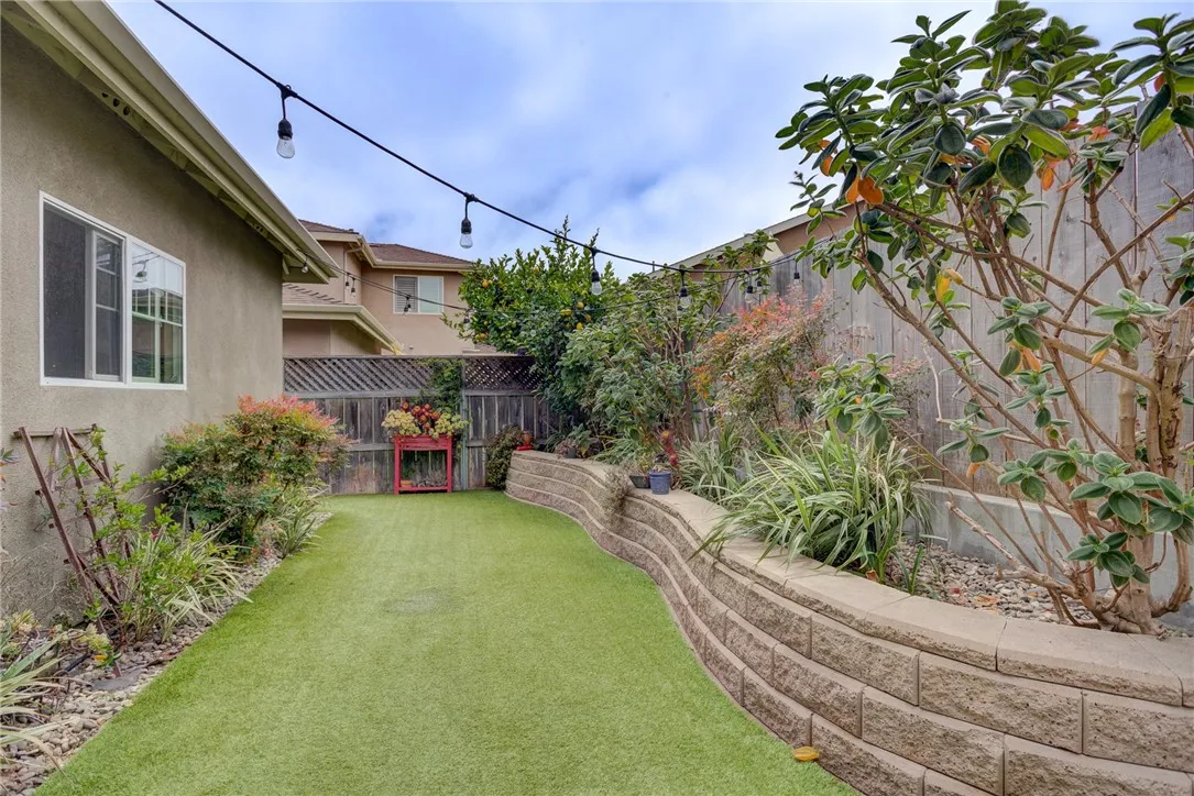 Backyard with artificial grass and raised planters Backyard with artificial grass and raised planters