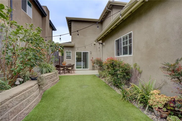 Backyard with artificial grass and raised planters