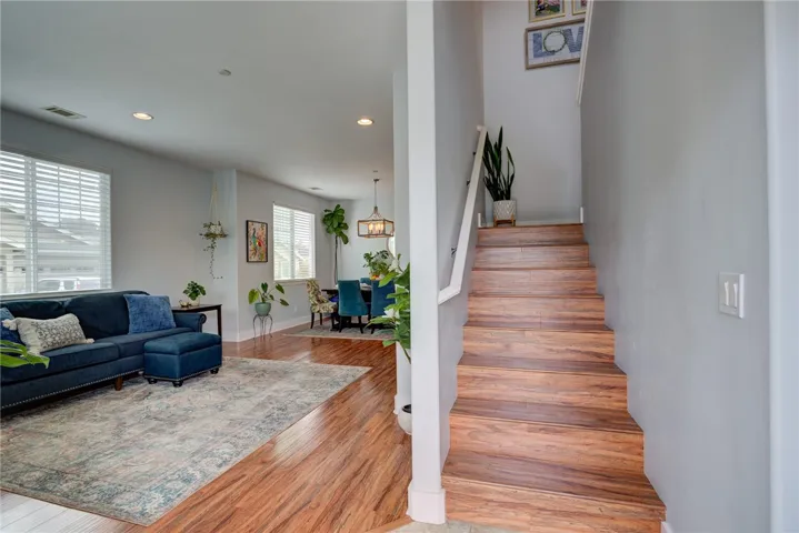 Entryway with living room to the left, hall bath, laundry, and primary bedroom to the right